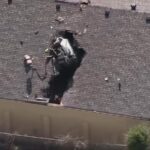 WATCH:  Car crashes through roof…again