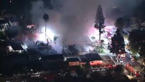 Over 100 firefighters battle fireworks blaze that leaves woman in critical condition